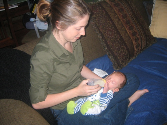 Hayley holding Alex as a newborn, feeding him a bottle